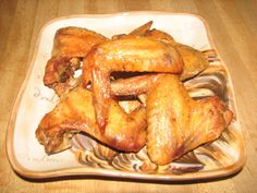 some chicken wings are on a plate ready to be cooked in the oven or used as an appetizer