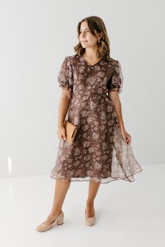 Introducing the 'Fawn', the midi dress with a perfect blend of ethereal beauty and elegance. Created with a delicate organza fabric and adorned with stunning florals, this dress promises to steal the show at any occasion. Whether you're attending a summer wedding or a romantic dinner date, its lightweight fabric and sophisticated design will carry an effortless grace. Self & Lining 100% Polyester Hand Wash Cold Do Not Bleach Hang to Dry Fully Lined Model Height 5'6" | Wearing Size Small Please carefully measure a similar item before placing your order to allow for the best fit and also to reduce the risk of returns. Have questions about fit? Call us! We try everything on, so we know how our clothes fit and we’re happy to assist you. Customer Service: 717.598.8309 9 AM - 3 PM EST All conver Spring A-line Chiffon Dress For Wedding Guest, Spring Wedding Guest A-line Chiffon Dress, Elegant Spring Floral Print Chiffon Dress, Elegant Floral Print Chiffon Dress For Spring, Modest Chiffon Summer Dress, Knee-length Chiffon Midi Dress For Wedding, Sheer Organza Dress With Short Sleeves, Sheer Organza Short Sleeve Dress, Modest Summer Chiffon Dress