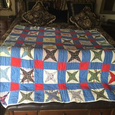 a quilted bed with red, white and blue stars on it