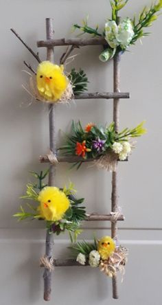 a bunch of fake flowers are arranged on a wooden ladder that is attached to the wall