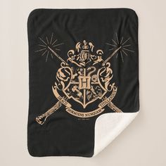 a harry potter blanket with two crossed swords