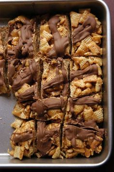 a tray filled with chocolate covered waffles and peanuts on top of each other