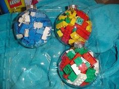 two ornaments made out of legos on a blue blanket