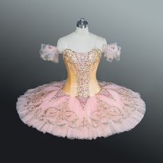 a pink and gold ballerina dress on display