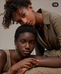 two women are posing for the camera with their hands on each other's shoulders