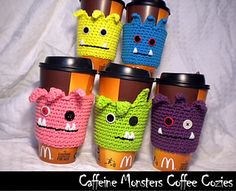 coffee cups with crocheted monsters on them