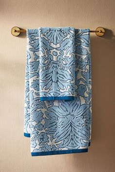 two blue towels hanging on the wall