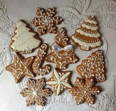 several decorated cookies sitting on top of a white doily