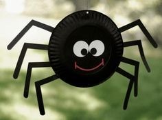 a paper plate spider hanging from a string