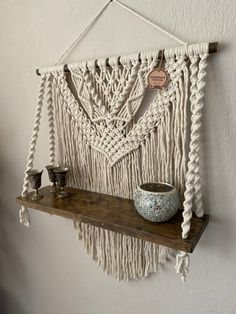 a macrame wall hanging on a shelf