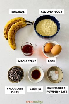 ingredients to make banana bread laid out on a white counter top, including bananas, eggs, maple syrup, vanilla, baking soda, and salt