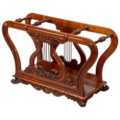 an old style wooden musical instrument with two pendulums on the front and back sides