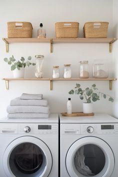 a washer and dryer sitting next to each other in front of some shelves