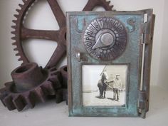 an old photo frame with two men on horses in front of some gears and cogwheels