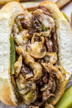 a sandwich with mushrooms and peppers on it