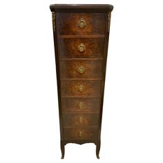 an antique chest of drawers with brass handles and knobs on the front, against a white background