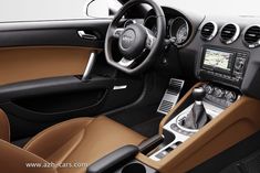 the interior of a car with brown and black leather