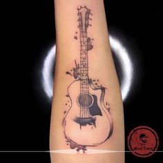 a black and white photo of a guitar tattoo