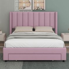 a pink bed with two pictures on the wall above it