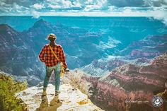 a man standing at the edge of a cliff looking out into the grand canyon below