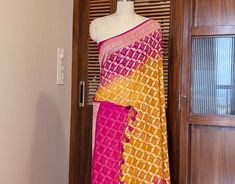 A lovely Pink Yellow Banarasi Bandhani Khaddi Georgette Saree in gorgeous pattern. Its a fusion of karigari of Banarasi and Gujarati. Additional Information Color : Pink Yellow Shaded Technique: Bandhani is a tye & dye technique in which fabric is pinched with nails and tied with thread and then dyed to create fabulous patterns. Fabric: Pure Georgette Blouse Piece: Included Since this product is handwoven, there might be slight irregularities. But doesn't that add to the singular charm of a handloom beauty? Fusion Style Fitted Dupatta With Traditional Drape, Fusion Style Pre-draped Saree With Pallu, Fusion Style Pre-draped Saree With Traditional Drape, Fitted Fusion Style Dupatta With Traditional Drape, Fusion Style Pre-draped Saree With Zari Work For Diwali, Fusion Style Pre-draped Saree With Zari Work, Fusion Style Pre-draped Saree With Zari Work For Navratri, Fusion Style Saree In Georgette With Traditional Drape, Festive Fusion Style Fitted Dupatta