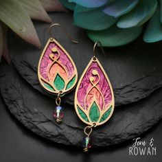 These Handmade Lotus Flower Bud Earrings are a beautiful gift for for anyone who is enchanted with the beautiful lotus flower!  These earrings feature a Colorful Lotus Flower that has been careful handmade and painted in our studio. The Lotus Flower symbol has used in many ancient cultures to represent spiritual awakening. Today it is seen as a sign of strength, resilience, and enlightenment.  These beautiful earrings have an eye-catching appearance that would look great with any outfit! These S Pink Teardrop Beads For Jewelry Crafting, Pink Teardrop Jewelry Beads For Crafting, Handmade Pink Teardrop Flower Earrings, Teardrop Pink Jewelry For Crafting, Bohemian Hypoallergenic Flower Earrings, Dangle Flower Earrings With Ear Wire For Mother's Day, Artistic Drop Flower Earrings As Gift, Artistic Flower Drop Earrings For Gift, Multicolor Bohemian Earrings With Flower Charm