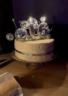 a cake that has some candles on top of it and is sitting on a table