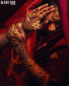 a woman with her hands covered in henna