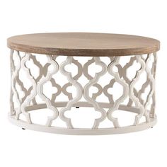 a white and wood coffee table with an intricate design on the top, against a white background