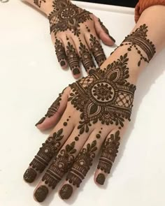 two hands with henna designs on them