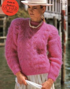 a woman wearing a pink sweater and hat