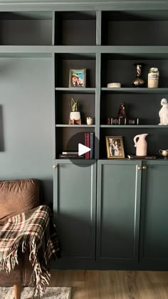 a living room filled with lots of furniture and bookshelves