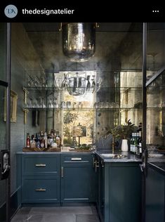 a kitchen with blue cabinets and glass shelves