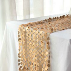 a gold table runner with circles on it