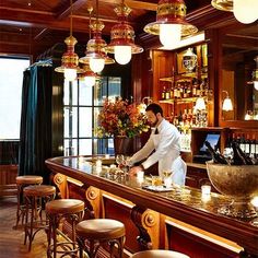 a man is behind the bar at a restaurant