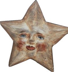 a wooden star with a face painted on it