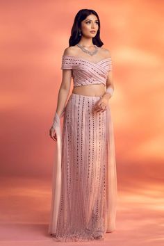 Pink straight skirt embellished with flat crystal beads, glass beads, and crystal drops over a net base.�Comes with embellished and padded off shoulder blouse and a dupatta.
Components: 3
Pattern: Embellished
Type Of Work: Flat crystal beads, glass beads, and crystal
Neckline: Off Shoulder
Sleeve Type: Short
Fabric: Net
Color: Pink
Other Details: 
Back cutout blouse
Attached lining
Approx. product weight: 1-2 Kgs
Occasion: Destination Wedding - Aza Fashions Straight Lehenga Skirt, Elegant Georgette Skirt Set For Party, Elegant Georgette Skirt Set For Reception, Glamorous Pearl Embroidered Party Lehenga, Glamorous Georgette Choli With Pearl Embroidery, Glamorous Party Lehenga With Pearl Embroidery, Elegant Embellished Skirt Set For Reception, Glamorous Lehenga With Pearl Embroidery For Party, Glamorous Designer Georgette Dresses