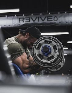 a man working on a wheel in a garage with the words revved written on it