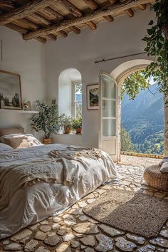 a bedroom with an arched doorway leading to the outside