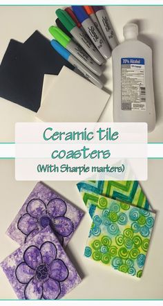 ceramic tile coasters with sharpie markers and crafting supplies on a white table