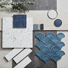 the blue and white tile is laid out on the floor next to each other, along with accessories