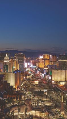 the las vegas strip is lit up at night with many buildings and lights on it