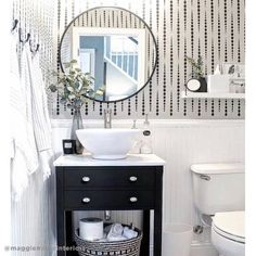 a bathroom with a sink, toilet and mirror in it's centerpieces