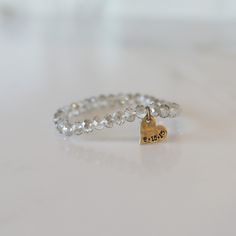 Add some bling to your wrist with our Personalized Crystal Stacks! You can personalize your stack bracelet with a name, date, initials, or a word of choice on a simple, classic disc charm. With neutral colors and faceted beads that shine and shimmer in the light, you can be reminded of a motivating word, memory, or special loved one whenever you look down at your wrist! A perfect gift for the everyday stack wearing lover! *Elastic stack bracelets are made with 6mm faceted crystals *Personalized Personalized Adjustable Crystal Bracelet, Adjustable Personalized Crystal Bracelet, Everyday Silver Charm Bracelet With Custom Name, Personalized Silver Beaded Bracelets For Everyday, Personalized Silver Crystal Bracelet, Adjustable, Everyday Silver Stackable Name Bracelet, Silver Stackable Name Bracelet For Everyday, Adjustable Hand Stamped Charm Bracelet For Everyday, Everyday Adjustable Hand Stamped Charm Bracelet