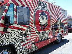 a red and white food truck parked in a parking lot