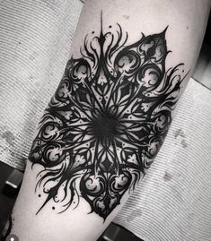 a black and white tattoo design on the arm