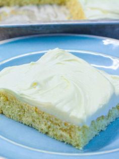 a piece of cake with white frosting on a blue plate