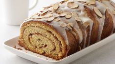 a loaf of cinnamon roll sitting on top of a white plate