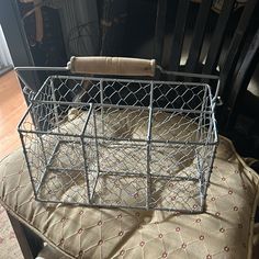 a metal basket sitting on top of a chair