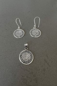 Aztec calendar jewelry for her Aztec pendant for ladies Aztec earrings handmade pendant sterling silver gift for woman real silver pendant Handmade Aztec calendar pendant and earrings with diamond cut around. This beautiful jewelry set is made of .925 silver, and the small notches cut into the metal links have a high polish to increase their sparkling reflections. The chain necklace is NOT included. Item Overview - Handmade in Mexico - Ships from CA, USA   Item Details - Charm diameter: 0.79 in Symbolic Silver Pendant Earrings, Silver Symbolic Pendant Earrings, Symbolic Silver Jewelry With Matching Earrings, Symbolic Sterling Silver Jewelry Gift For Her, Spiritual Silver Pendant Earrings, Silver Pendant Spiritual Earrings, Sterling Silver Earrings With Round Pendant, Silver Pendant Earrings, Spiritual Style, Silver Sterling Silver Earrings With Round Pendant